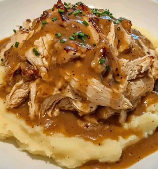 SAVORY SHREDDED CHICKEN WITH CREAMY GRAVY OVER MASHED POTATOES